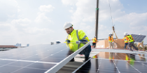 Technicien de maintenance installant et vérifiant des panneaux solaires sur un site industriel